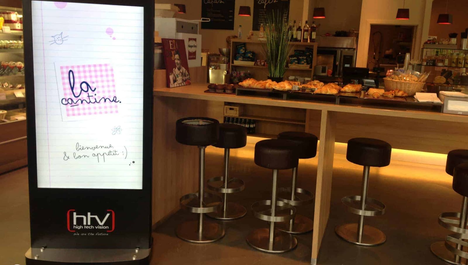 La Cantine café, Belgium: a portrait totem by HTV at the counter