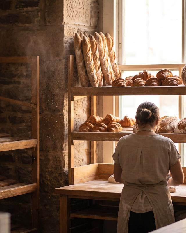 Baguettes and croissants on bakery shelves